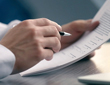 a man reading the terms and conditions with a pen in hand.